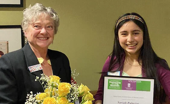Image of Sariah Palacios receiving Violet Richardson Award from Mary Long